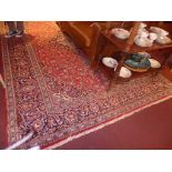 A fine central Persian Kashan carpet 365 x 250 cm central pendant floral on rouge field with Shah