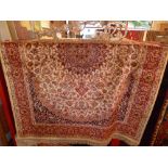 A Persian Keshan style rug the beige field having central foliate medallion and floral motifs in a