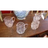 A collection of four cut glass and moulded glass jugs