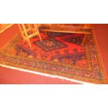 A fine North West Persian Heriz carpet triple pole medallion on a rouge field within stylized