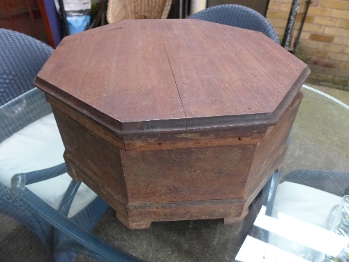 An octagonal hardwood garden storage box with lid