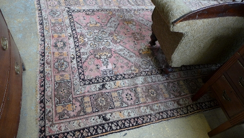 An antique carpet geometric with pink and beige ground