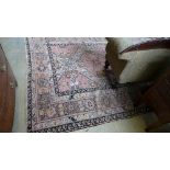 An antique carpet geometric with pink and beige ground