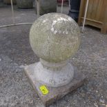 A reconstituted stone ball on stand