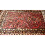 A fine North West Persian Sarouic runner 295 cm x 80 cm repeating floral motifs on a terracotta