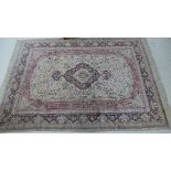 An handwoven silk rug the ivory field with dark indigo central pole medallion within indigo border