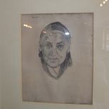 An etching of an elderly woman, framed and glazed