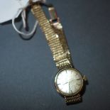 A ladies Omega wristwatch having a hand wound mechanical movement on a 9 ct gold bracelet
