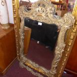 An ornate gilt wood framed wall mirror