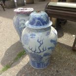 A pair of blue and white Chinese vases with lids