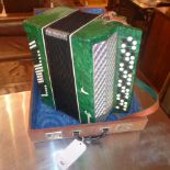 A Paccgem accordian in green faux mother of pearl with case
