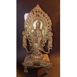 A gilt metal Asian shrine with deities i