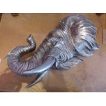 A pair of silvered elephant mask wall pl