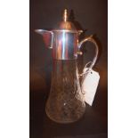 A silver plated and cut glass claret jug