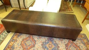 A brown leather banquette of rectangular block form