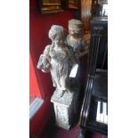 A pair of stoneware sculptures of ladies raised on square section plinth bases