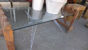 A Conran glass top dining table of industrial style having metal and wire work angled metal