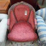 A C19th French carved bergere upholstered in faded red fabric on tapering turned supports