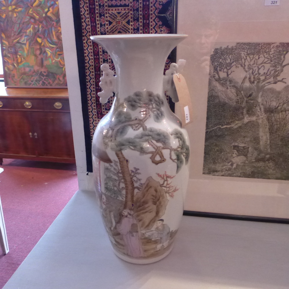 A Chinese porcelain vase decorated with two gentleman in a landscape setting and calligraphy