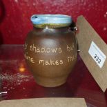 A pottery jug engraved 'Life Has Many Shadows But Tis The Sunshine Makes Them' signed indistinctly