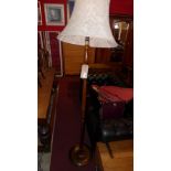 A turned walnut standard lamp with shade and one other (2)