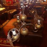 A brass globe form hanging chandelier with orange glass shades and the matching wall lights and