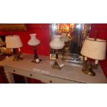 A pair of French style twin light table lamps and a similar pair