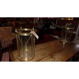 A pair of large brass and glass cylindrical form storm lanterns