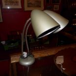 A 1950's American twin desk lamp on chromed adjustable supports on a circular base