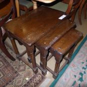 A nest of three oak tables