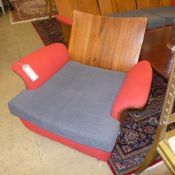 A pair of G-plan shaped teak easy chairs upholstered in red woolen fabric and having a cushion