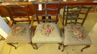 A set of three Chippendale style chairs with one carved and needlework seats