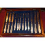 A cased set of silver plated mother of pearl handled knives and forks