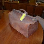 A vintage brown leather Gladstone bag