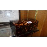 An unusual parquetry decorated tortoiseshell jewellery casket with domed top and baize lined