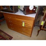 A Ministry of Defence mahogany desk with formica inset top above arrangement of drawers