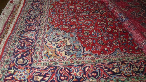 A fine central Persian Sarouk rug 237 cm x 135 cm central floral medallion on a terracotta field