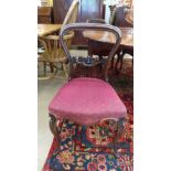 A set of four Victorian mahogany balloon back dining chairs with serpentine stuff over seats on