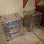 A pair of aviator design metal clad bedside chests having two drawers