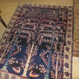 A C19th handwoven North West Persian carpet the indigo field with "tree of life" design and with