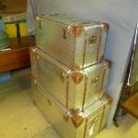 A graduated set of three aviator trunks with hinged lid