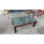 A mahogany low table having green marble inset top on square section supports