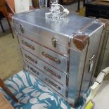 An aviator chest with hinged top over three long drawers on plinth base