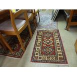 A Persian style carpet with all over floral pattern and two others