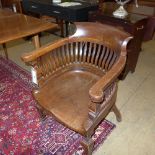 A pair of Victorian oak office chairs of tub form with slatted back above solid seat on stretchered