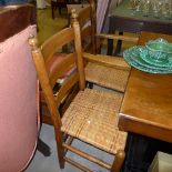 A set of four ash ladder back chairs with woven rattan seats on stretchered turned supports
