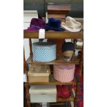 A collection of boxed hats including a Harrod's hat and hat stands