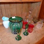 A large collection of drinking glasses including coloured examples, a green jardiniere and others