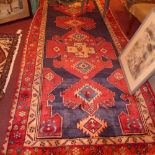 A Persian Sarab rug the navy blue field having central geometric lozenges in a floral double