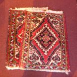 A pair of Persian hand knotted prayer rugs with diamond lozenge and floral motifs